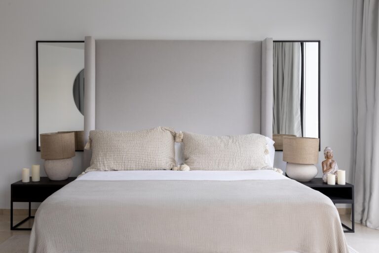 Simple and clutter-free minimalist bedroom design featuring neutral colors and sleek decor elements.